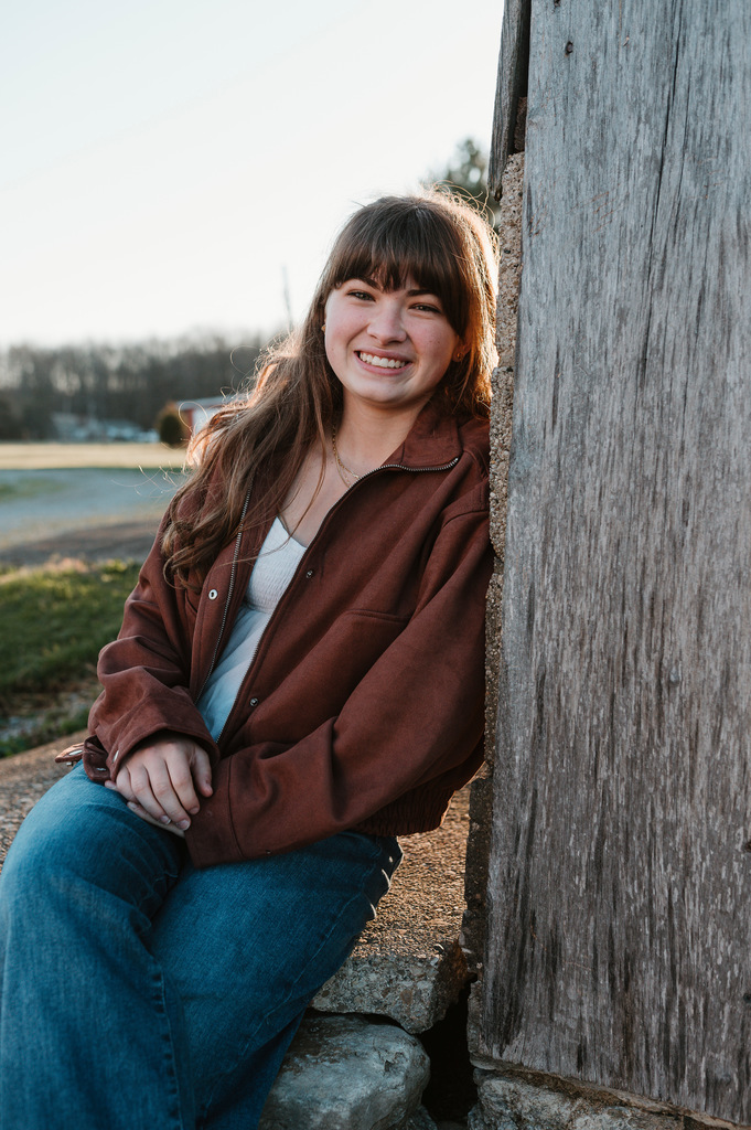 Photo of a girl leaning on a tree 
