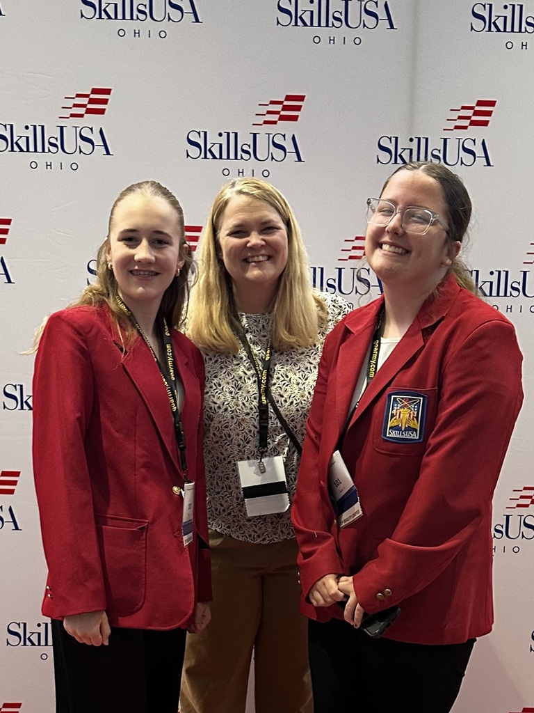 three students in front of usa skills sign