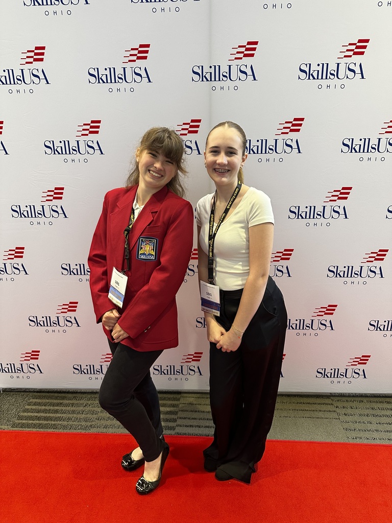 two students in front of skills usa background
