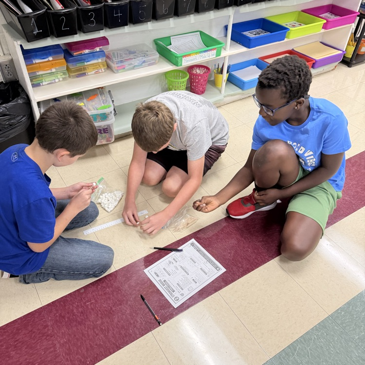Mrs. Senger’s sixth graders designing bridges with marshmallows and toothpicks to see which holds the most weight.