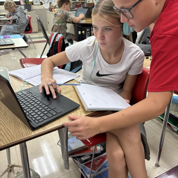 Sixth grade students in Mrs. Carnahans class working together to review decimal operations.