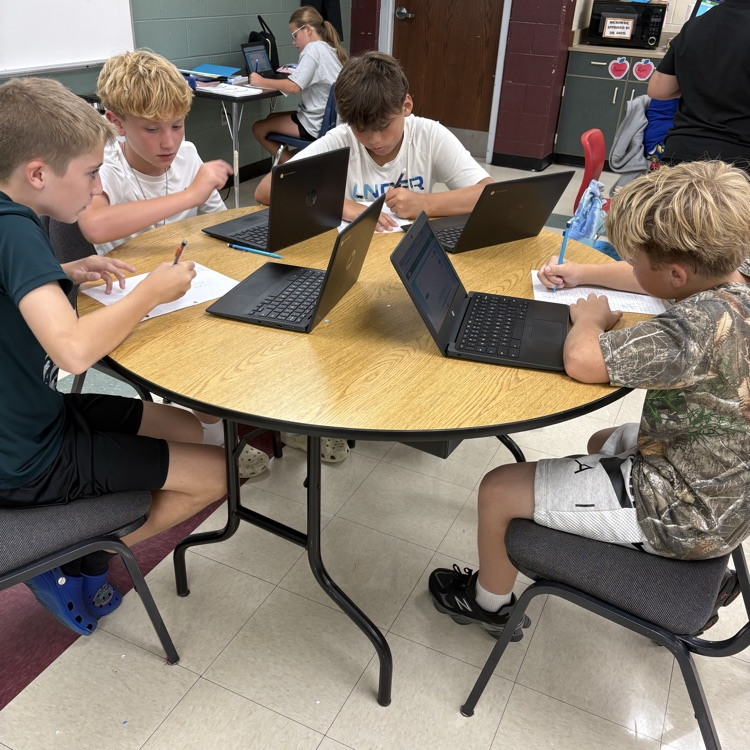Sixth grade students in Mrs. Carnahans class working together to review decimal operations.