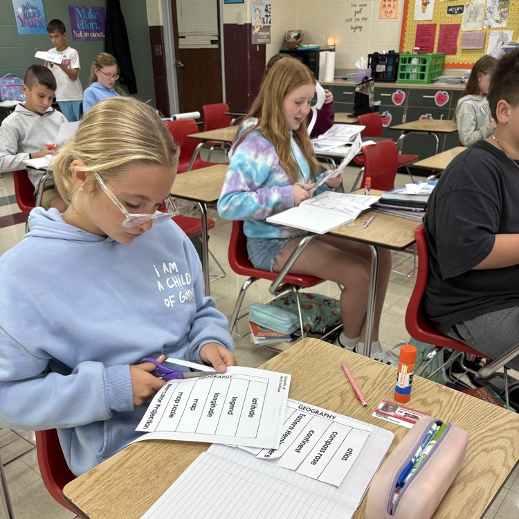 Mrs. Carnahans class using their interactive notebooks to make flashcards for geography terms. 