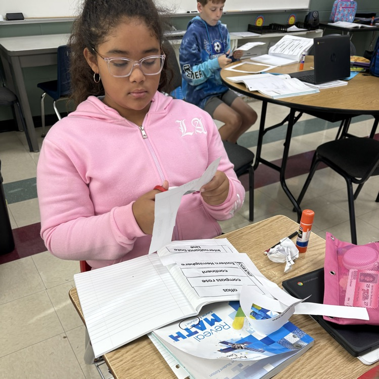 Mrs. Carnahans class using their interactive notebooks to make flashcards for geography terms. 