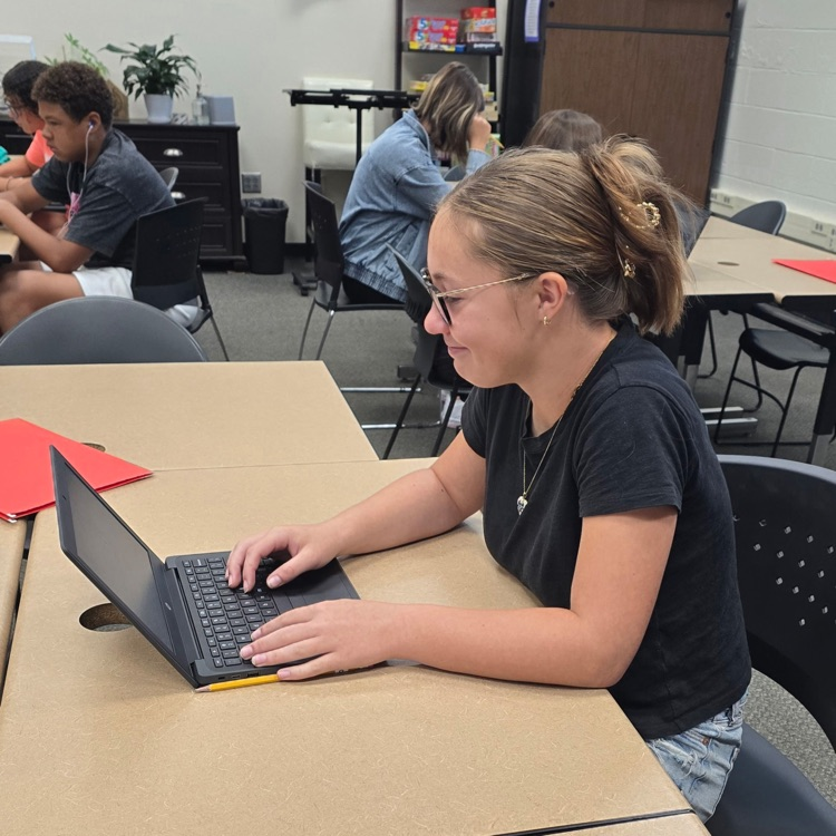 8th graders in Career Exploration set up their slides for the presentation they will be giving on a job they research.