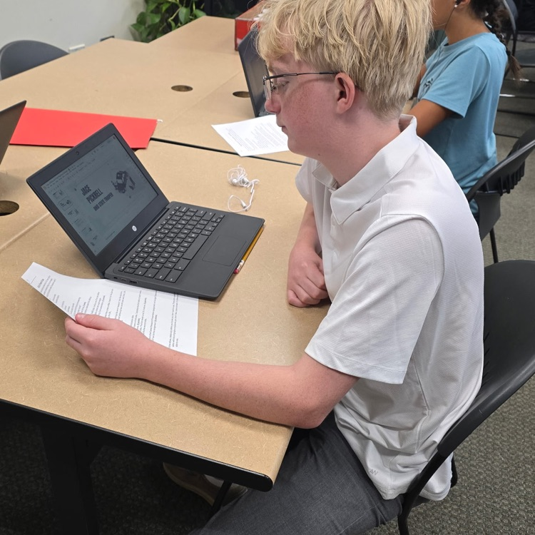 8th graders in Career Exploration set up their slides for the presentation they will be giving on a job they research.
