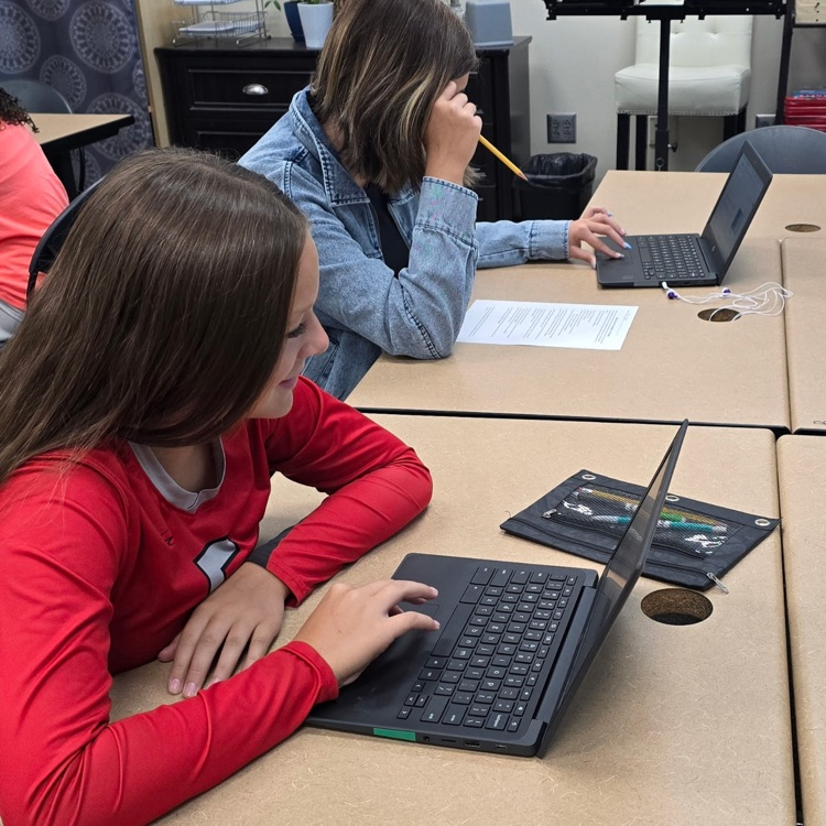 8th graders in Career Exploration set up their slides for the presentation they will be giving on a job they research.