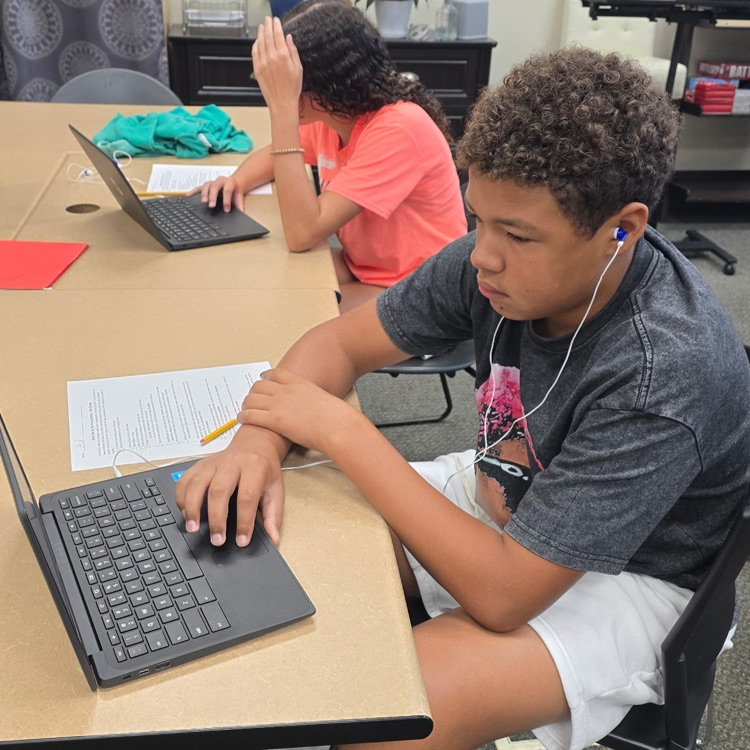 8th graders in Career Exploration set up their slides for the presentation they will be giving on a job they research.