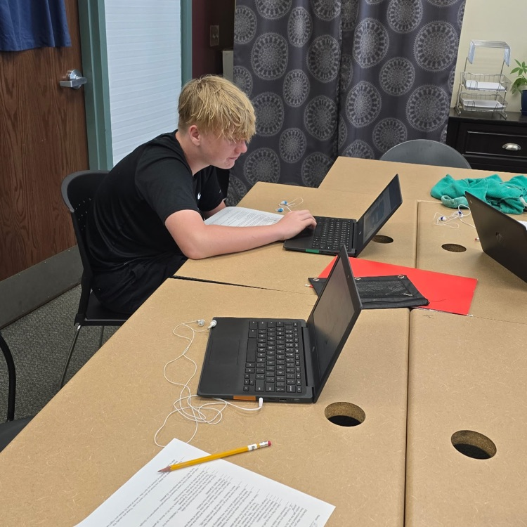 8th graders in Career Exploration set up their slides for the presentation they will be giving on a job they research.