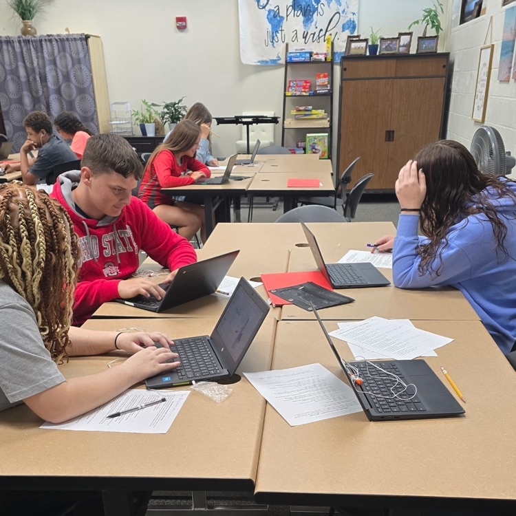 8th graders in Career Exploration set up their slides for the presentation they will be giving on a job they research.