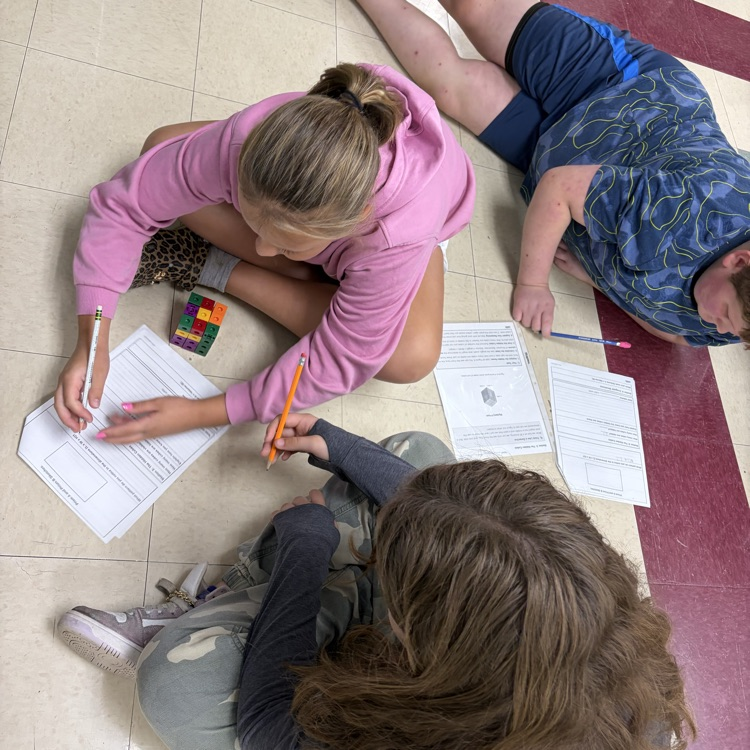 The 5th grade students were working on volume stations to review for their volume test. 