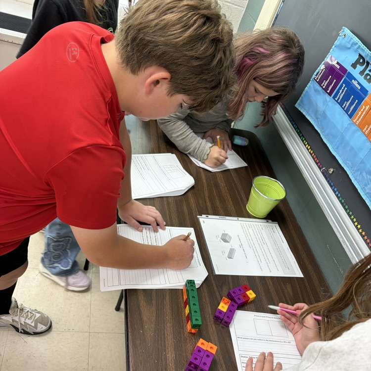 The 5th grade students were working on volume stations to review for their volume test. 
