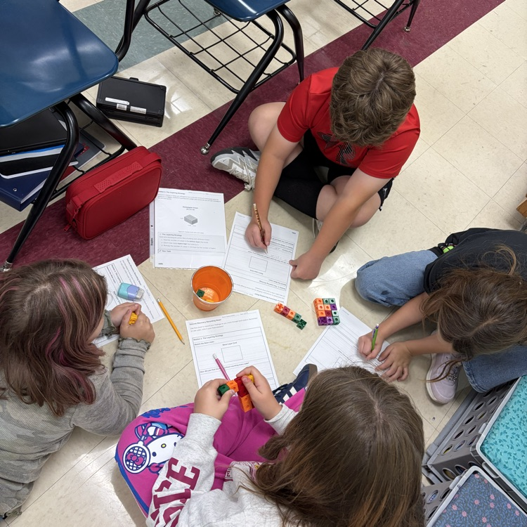 The 5th grade students were working on volume stations to review for their volume test. 