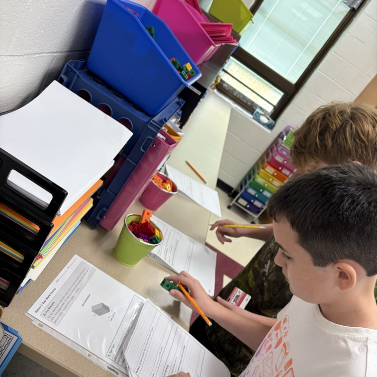 The 5th grade students were working on volume stations to review for their volume test. 