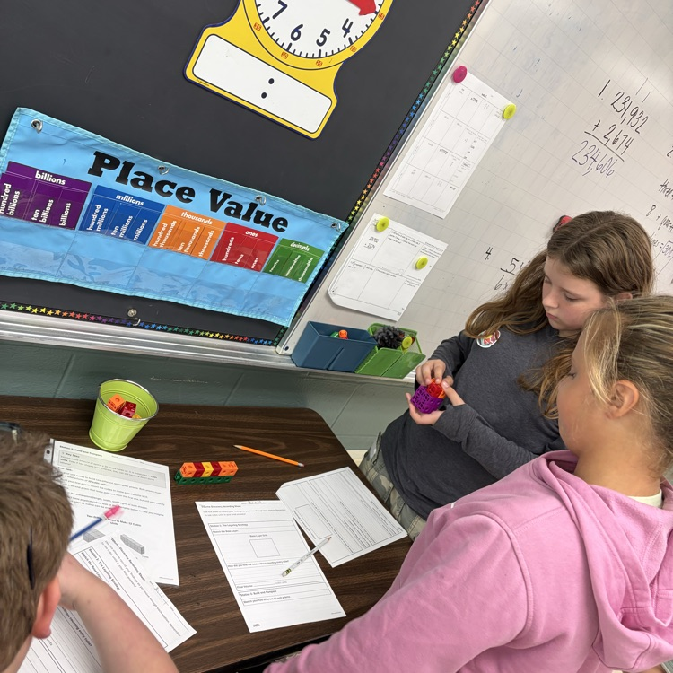 The 5th grade students were working on volume stations to review for their volume test. 