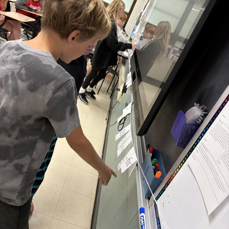 Students were solving algebraic equations and placing the final answer on the number line in the spot it should be on and why.