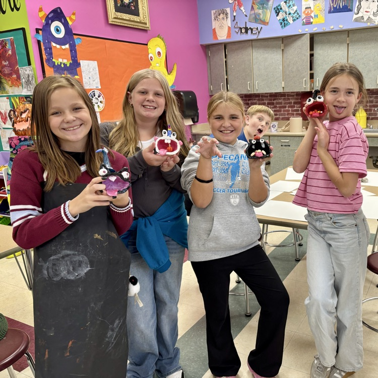 Some of the 5th grade Art students with their finished clay monster pinch pots.  They did outstanding on them!!