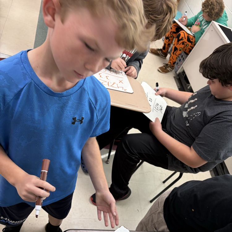 5th graders playing math jeopardy to review for their unit test 