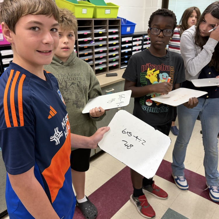 6th graders playing math jeopardy to review for their unit test 