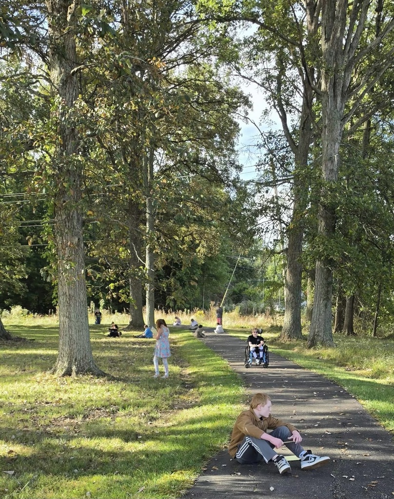 Students spent time in a “sit spot” to jot down what they could hear, feel, see, and smell. They used their notes for a piece on descriptive writing.