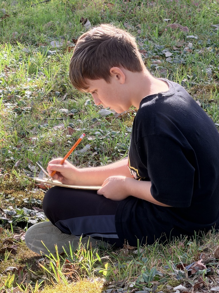 Students spent time in a “sit spot” to jot down what they could hear, feel, see, and smell. They used their notes for a piece on descriptive writing.