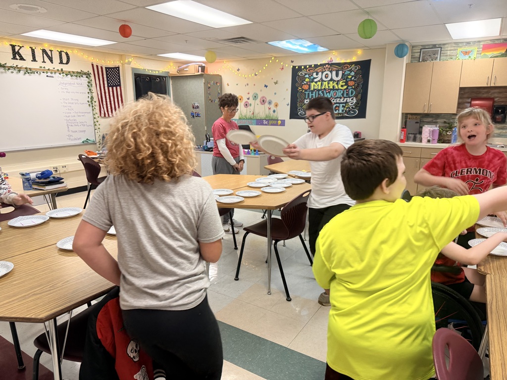 Students challenge other teams in paper plate races to study for a test. 