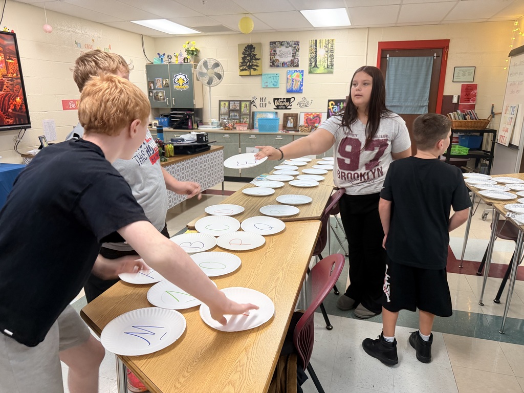 Students challenge other teams in paper plate races to study for a test. 