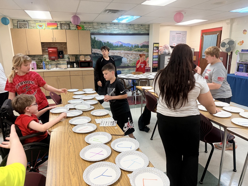 Students challenge other teams in paper plate races to study for a test. 