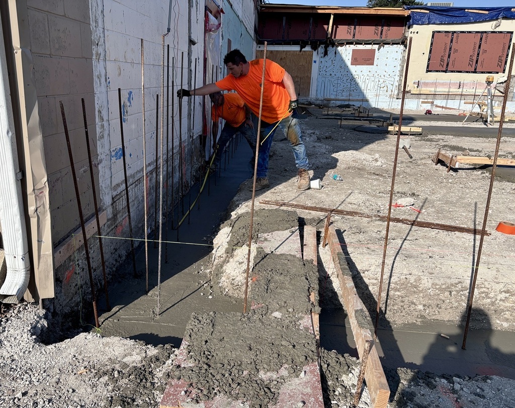 Crews pouring footings