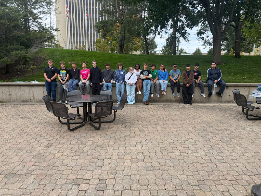 BHS Sinclair Field Trip - Students sitting on a half wall outside in the picnic area