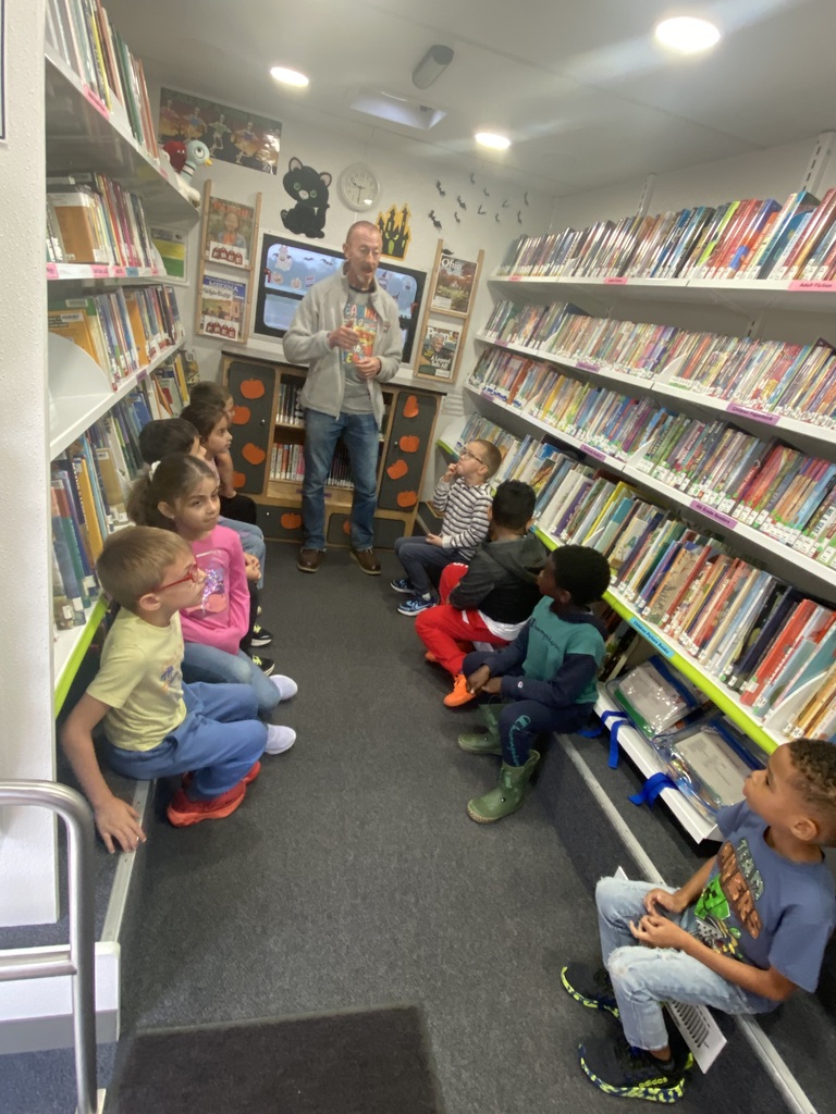 1st Graders in the Bookmobile surrounded by shelves of books