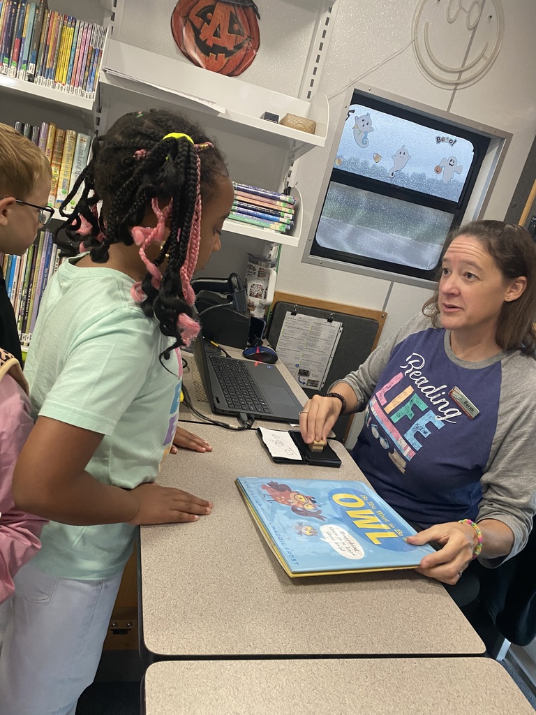 A first grader checking out a book from the bookmobile
