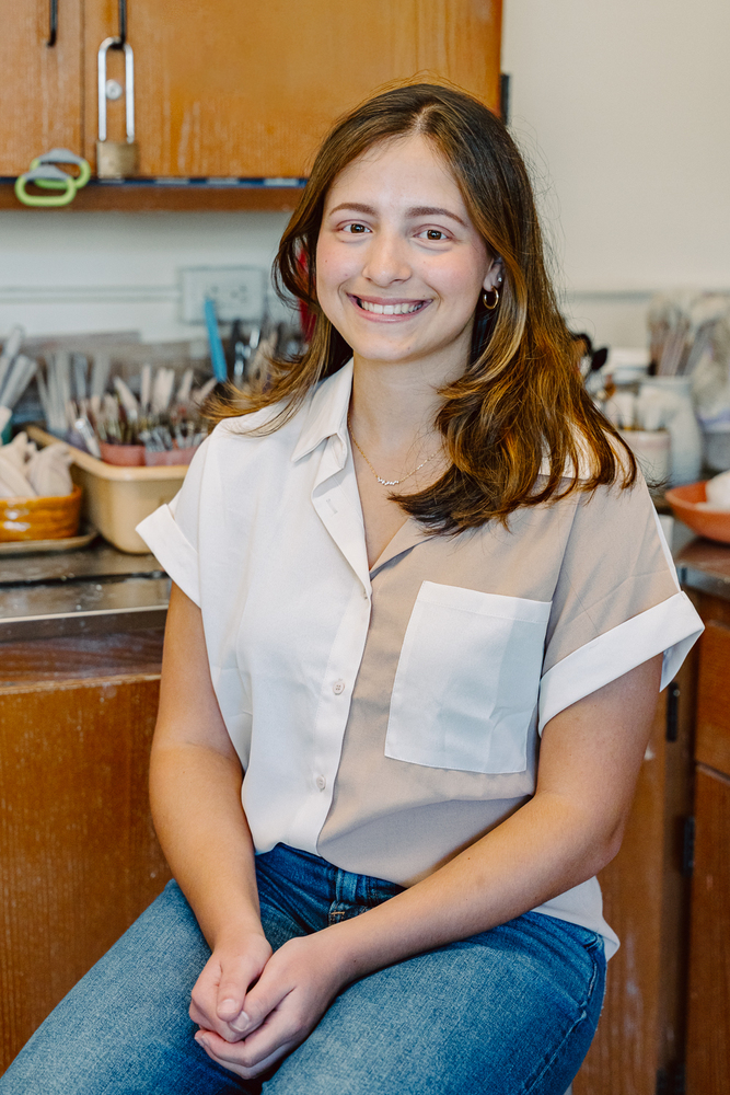 Student sitting in art room.