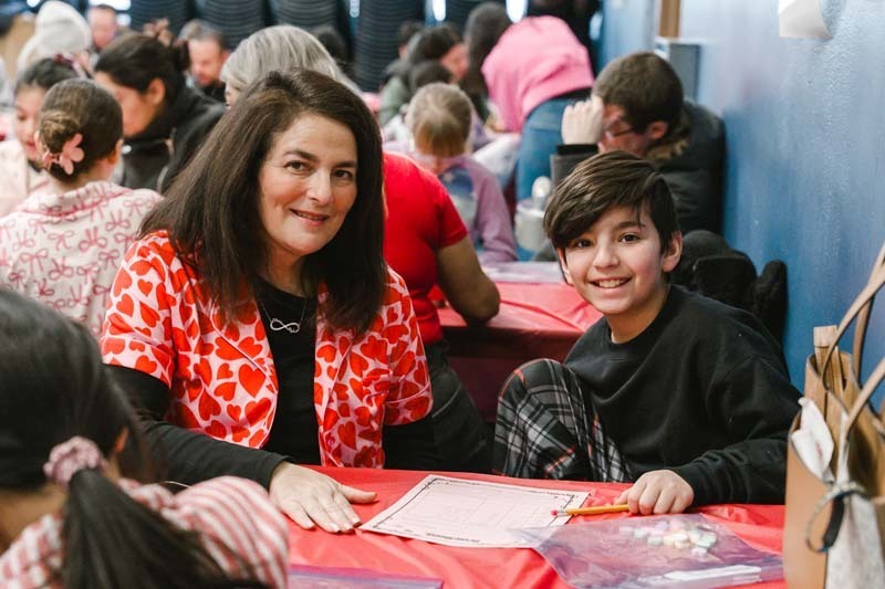 Student and teacher smiling together.
