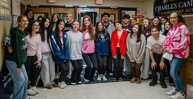 Students standing together in hallway.