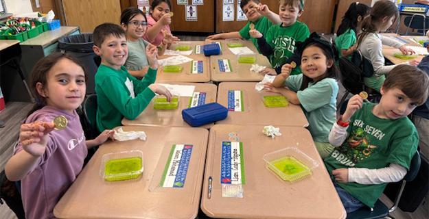 Students smiling while working on their projects.