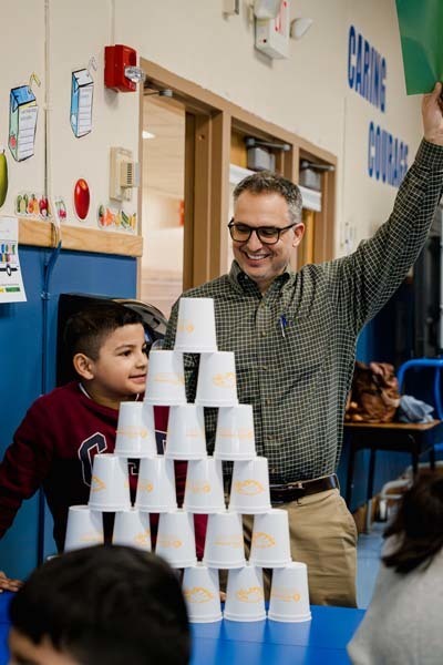Student and parent stacking cups.