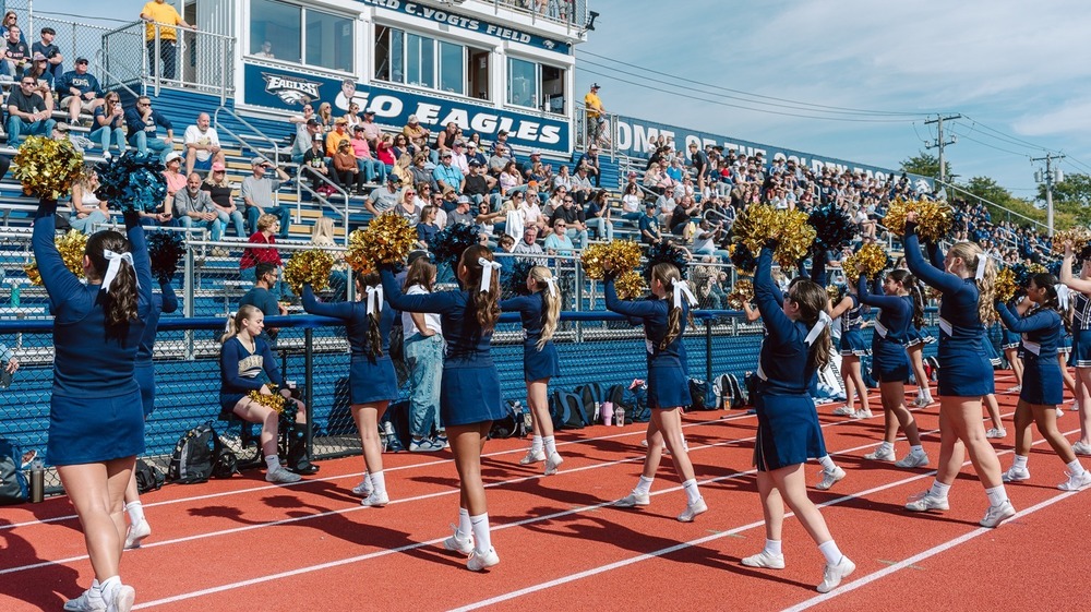 Bethpage High School marching band parade on high school sports track cheerleaders cheering