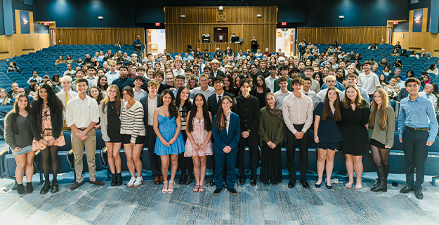 Student group photo in auditorium.