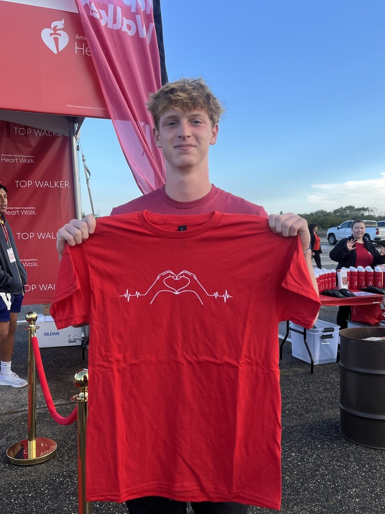 Aidan Lyons holding up a t-shirt at the Long Island Heart Walk