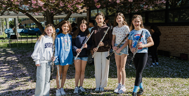 Students standing outside in garden.