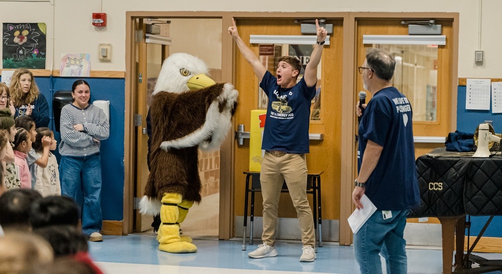 student and mascot in gym