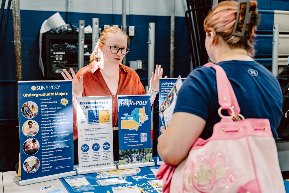 Students speaking to each other at college fair.