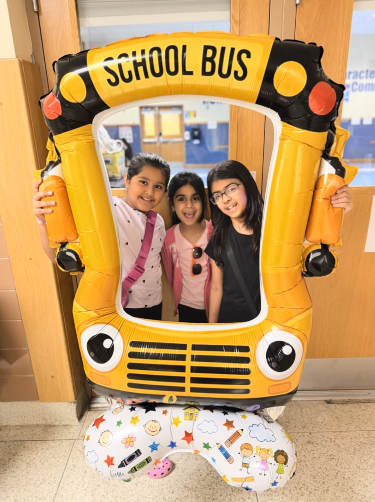 Students standing inside inflatable school bus.