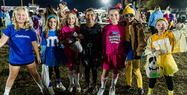 Students dressed up in costumes outside/