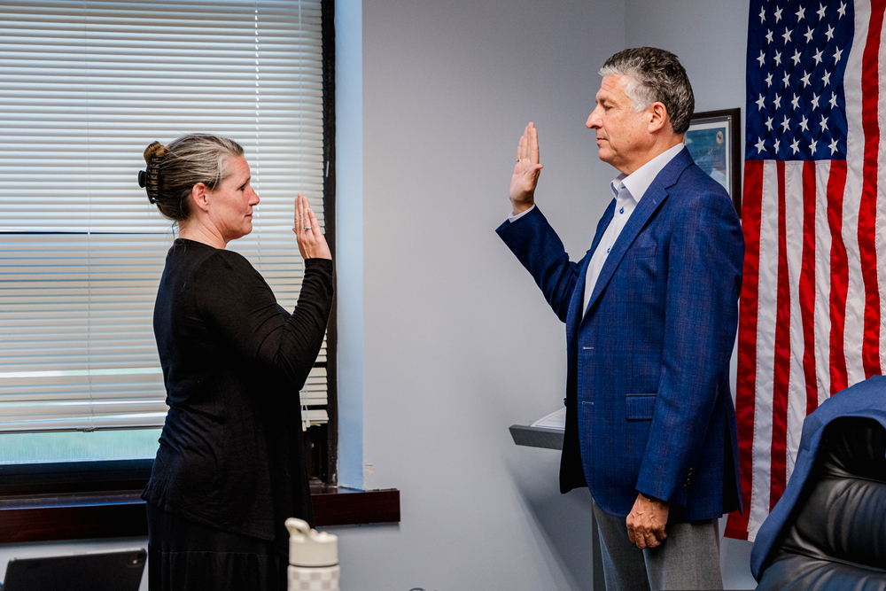 Board member being sworn in.