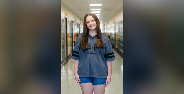 girl in hallway wearing jersey