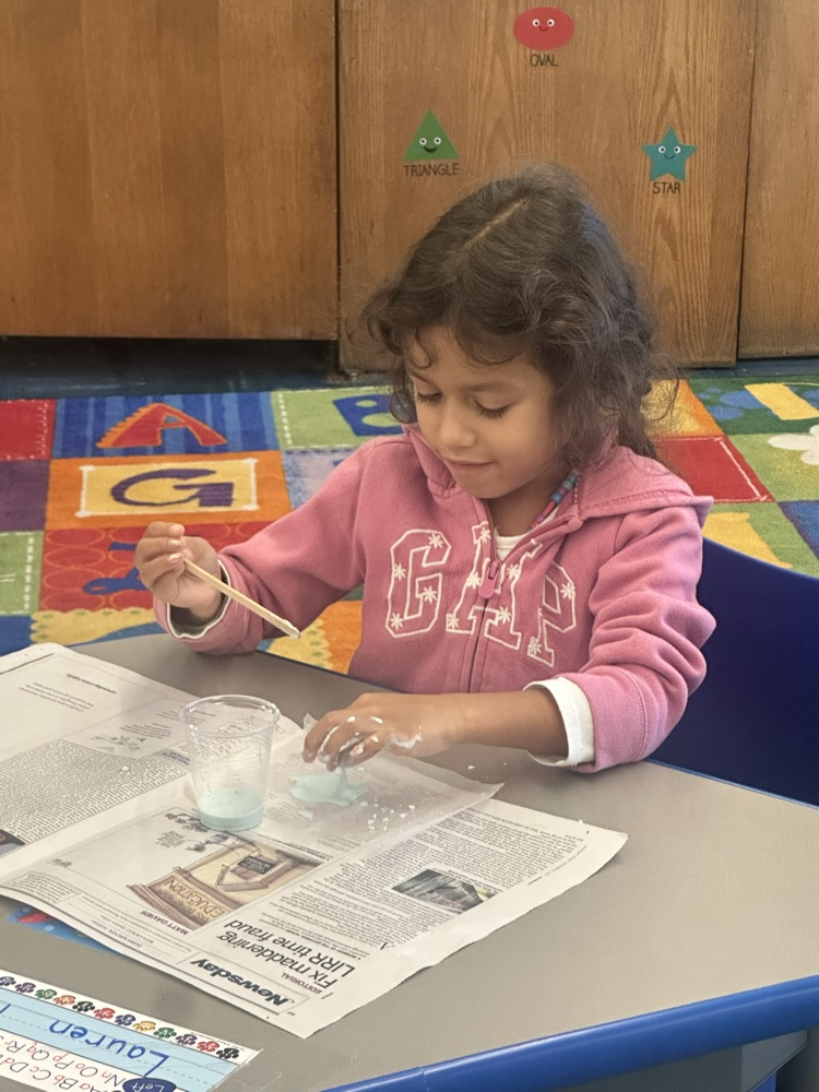 Grade one making Oobleck.