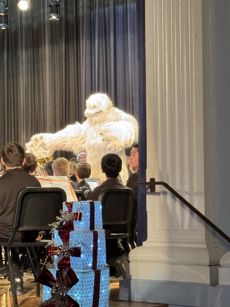 The abominable  snowman visits the stage as the 6th grade band performs at the Winter Concert Part III