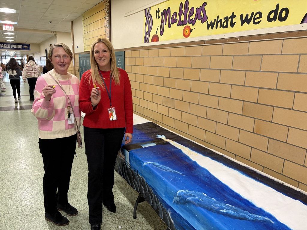Principal Hayes and Ms. Bula prepare to sign the lighthouse art mural for P.S. I Love You Day
